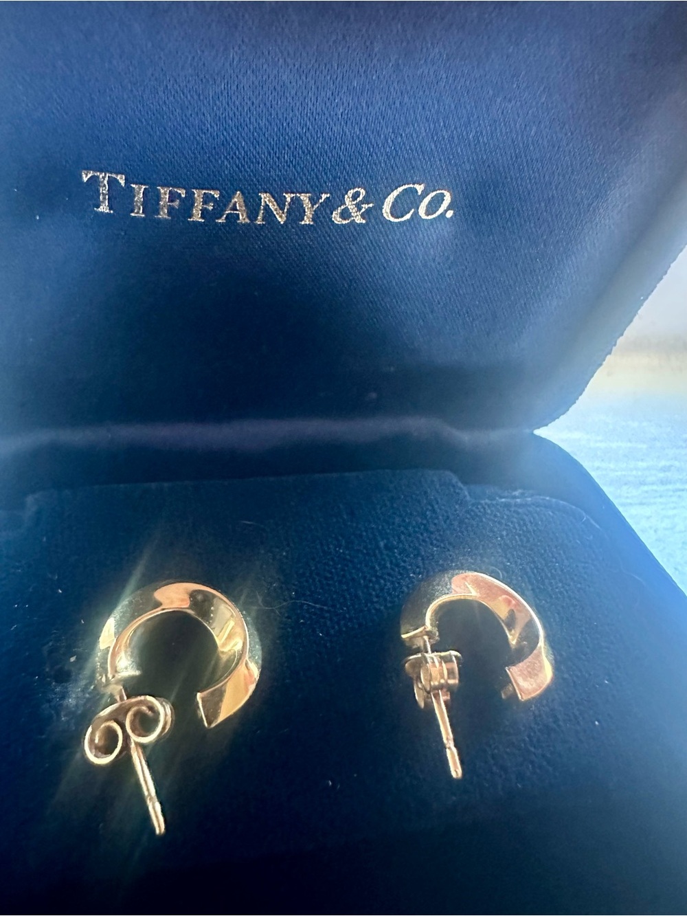Tiffany Co. 18k yellow gold twisted hoop earrings. With original box.